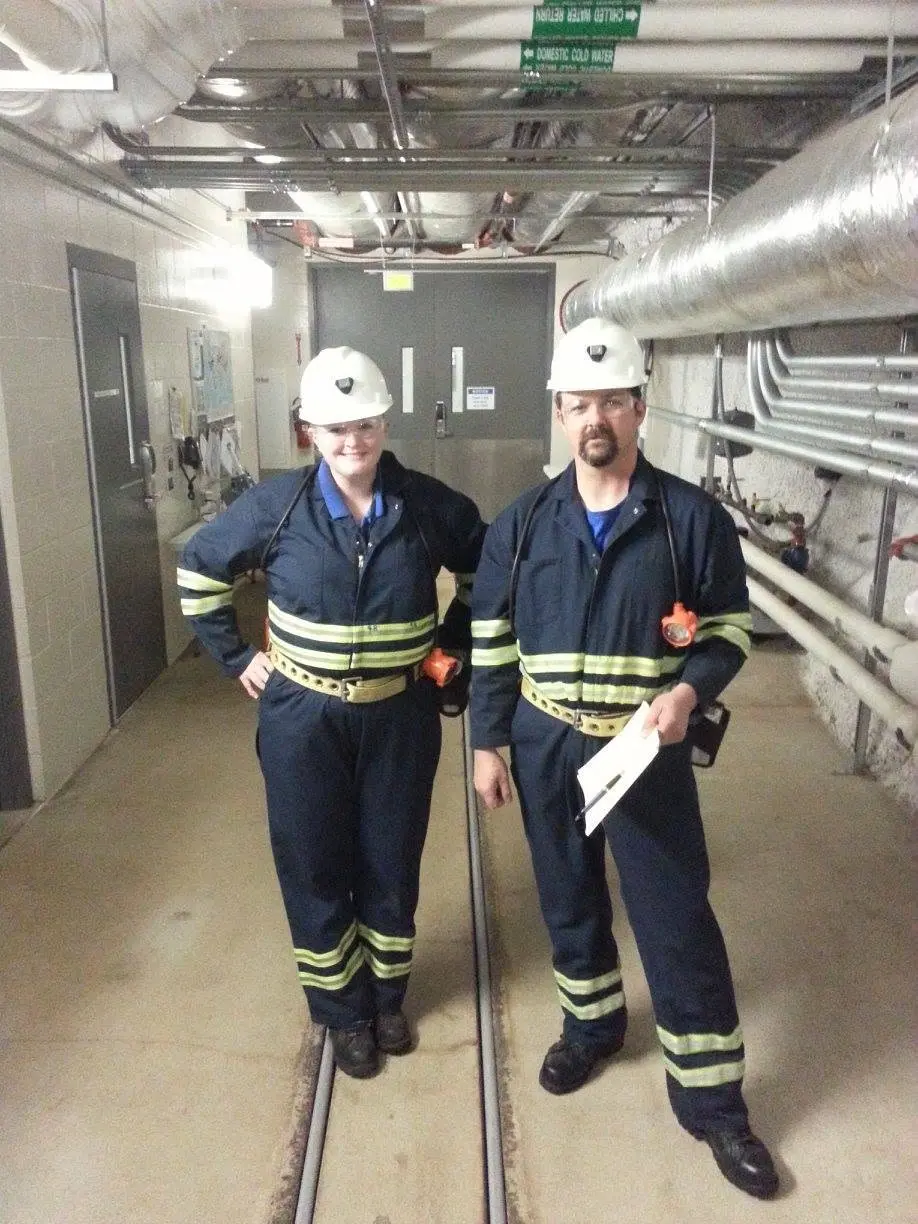 Two True Clean team members prepared for work in a specialized commercial facility