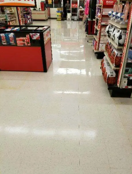 The same retail store floor after professional cleaning, clean and polished